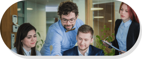 The TechDot team collaborating around a laptop